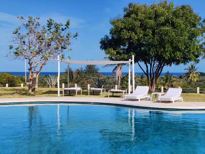 Le Pleiadi swimming pool with the Indian Ocean visible beyond