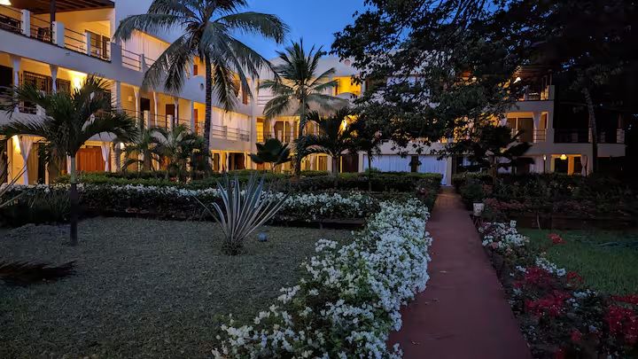 Le Pleiadi apartments and tropical courtyard at dusk